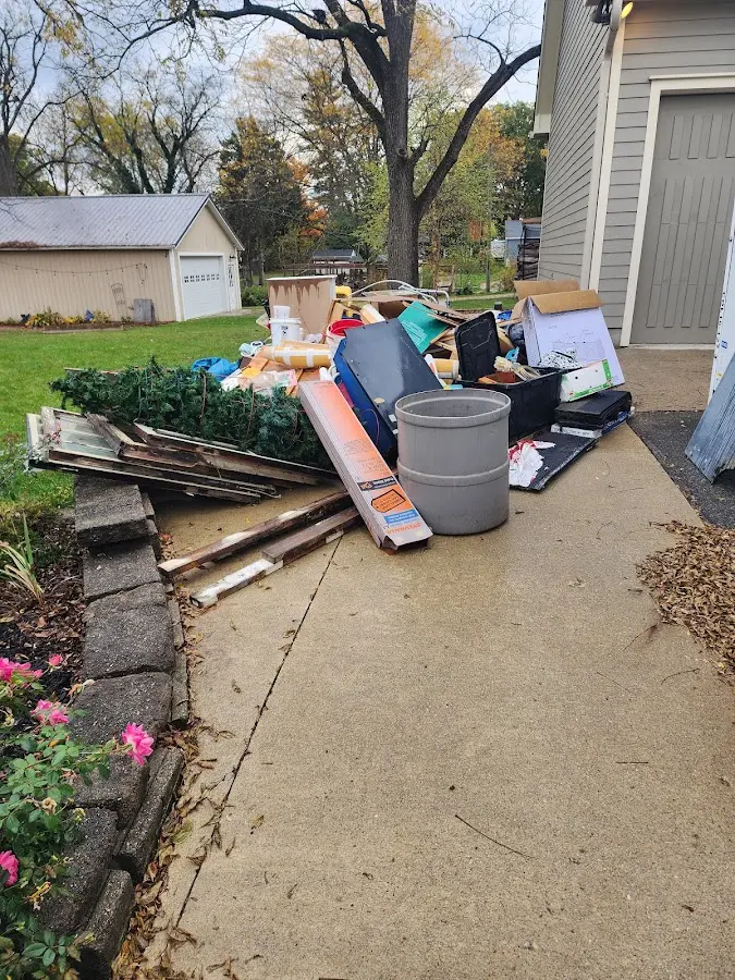 Dumpster being loaded with debris for 12 Yard Dumpster Rental in Timberville